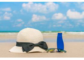 白色沙滩上的太阳镜防晒霜和帽子_1017690