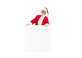 指向空白的广告横幅的愉快的惊奇的圣诞老人_13057492